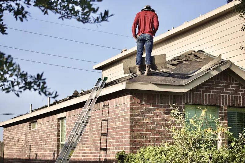 Professional roofer working on a residential roof in North Laurel